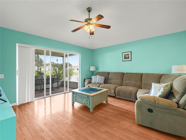 living room with light hardwood / wood-style flooring and ceiling fan