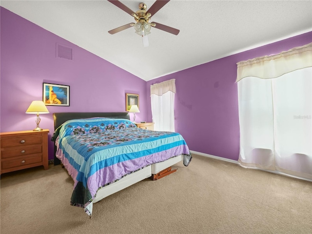 bedroom with lofted ceiling, ceiling fan, and carpet floors