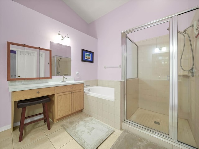 bathroom with independent shower and bath, lofted ceiling, vanity, and tile patterned flooring