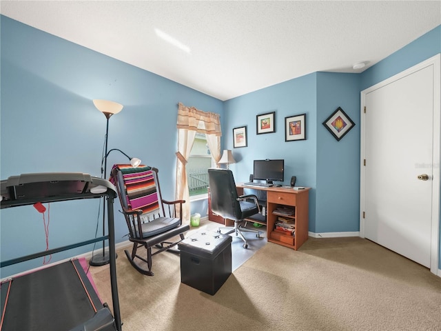 home office with a textured ceiling and carpet flooring