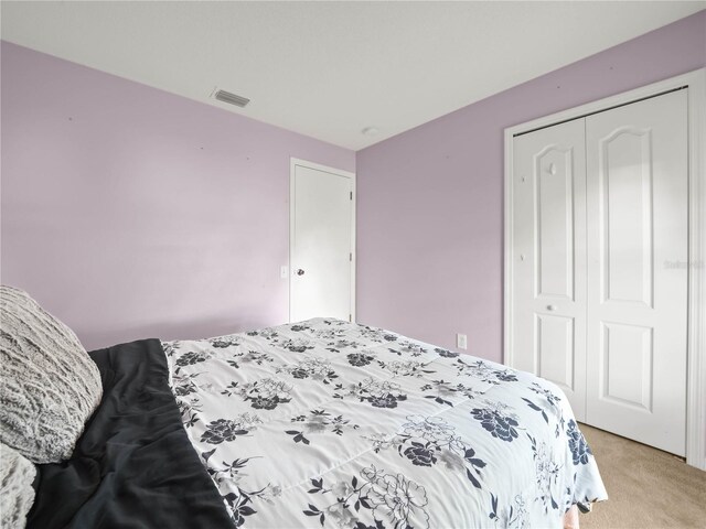 carpeted bedroom featuring a closet