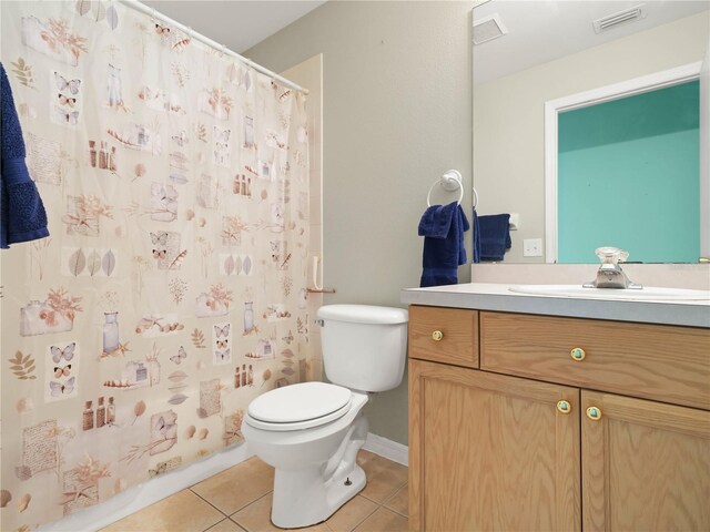 full bathroom featuring shower / bath combo, tile patterned flooring, vanity, and toilet