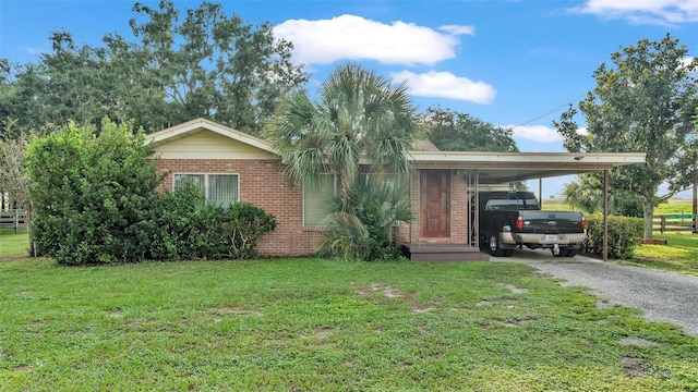 ranch-style house featuring a front lawn and a carport