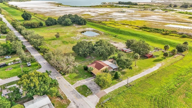 birds eye view of property featuring a water view and a rural view