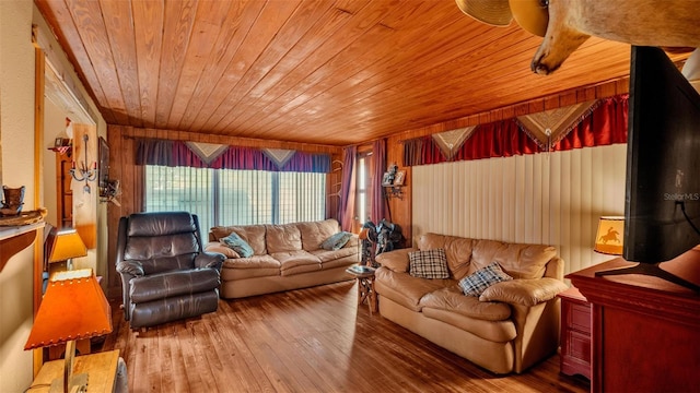 living room with hardwood / wood-style flooring, wood walls, and wooden ceiling