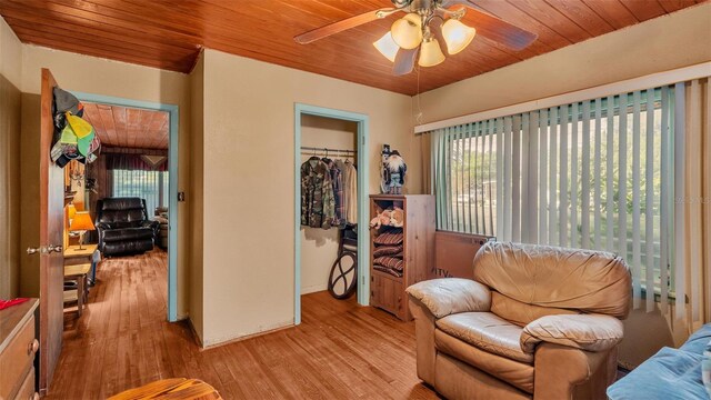 sitting room with wood ceiling, a wealth of natural light, light hardwood / wood-style floors, and ceiling fan