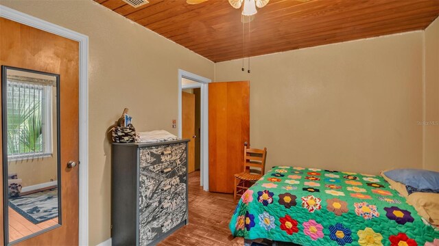 bedroom featuring wooden ceiling, ceiling fan, and hardwood / wood-style flooring