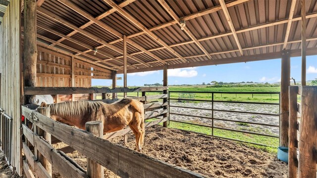 view of stable with a rural view and a water view