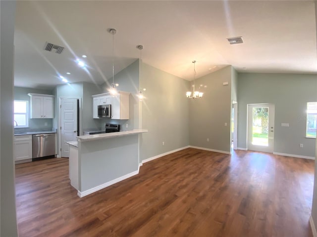 kitchen featuring open floor plan, appliances with stainless steel finishes, visible vents, and white cabinets