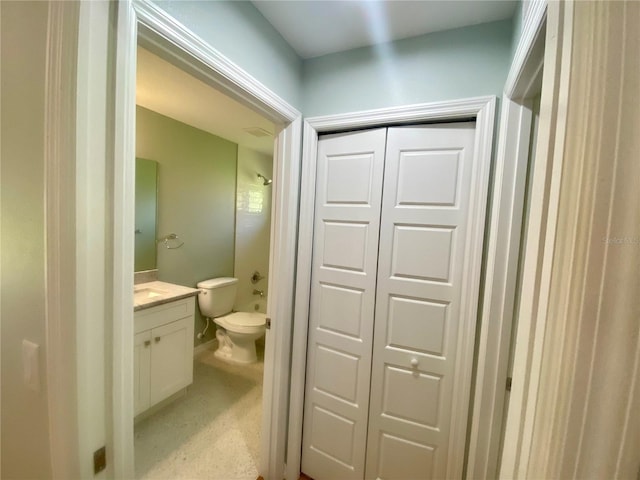 bathroom featuring toilet, shower / bathing tub combination, and vanity