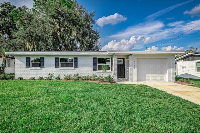 ranch-style home with a garage and a front lawn