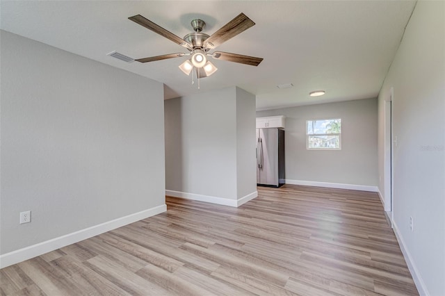 unfurnished room featuring light wood-type flooring and ceiling fan