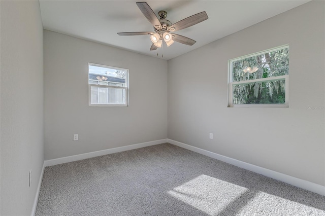 carpeted spare room with ceiling fan