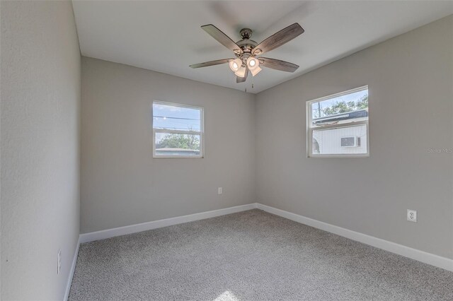 carpeted empty room featuring ceiling fan