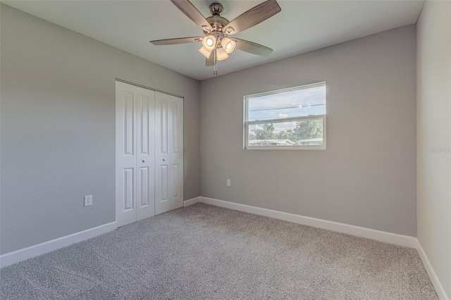 unfurnished bedroom featuring carpet flooring, ceiling fan, and a closet