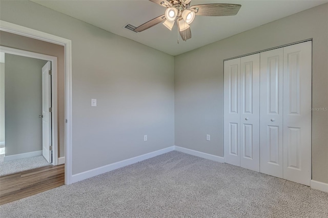 unfurnished bedroom featuring a closet, carpet, and ceiling fan