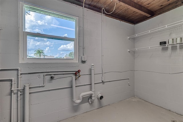 clothes washing area with wood ceiling