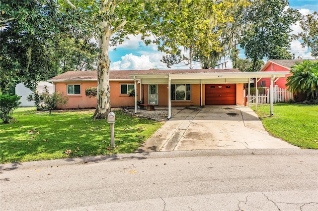 single story home featuring a front lawn and a carport