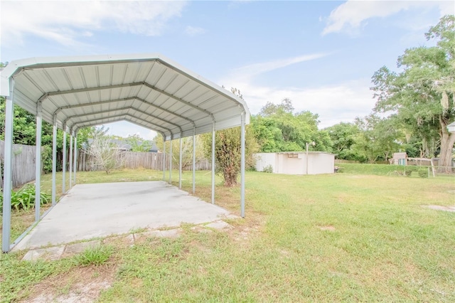 view of yard featuring a storage shed and a carport