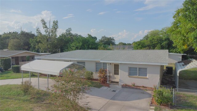 ranch-style house with a carport and central air condition unit