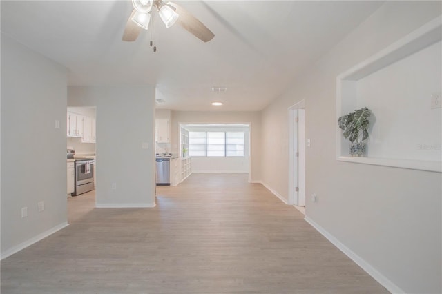 hallway with light hardwood / wood-style floors