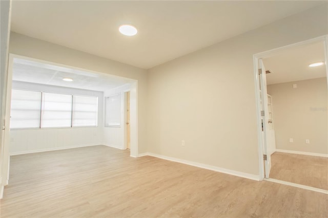 empty room with light hardwood / wood-style flooring