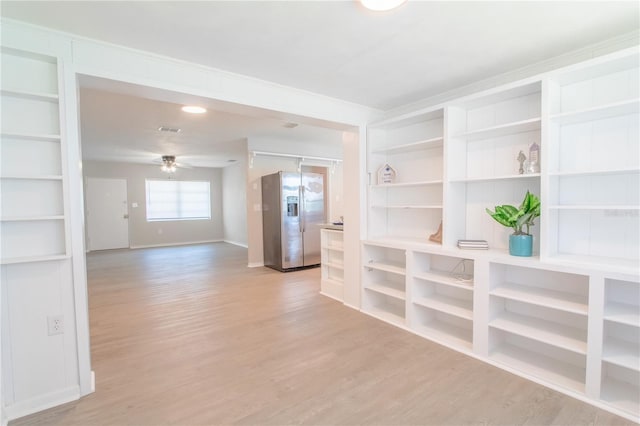 spare room with light hardwood / wood-style flooring and ceiling fan