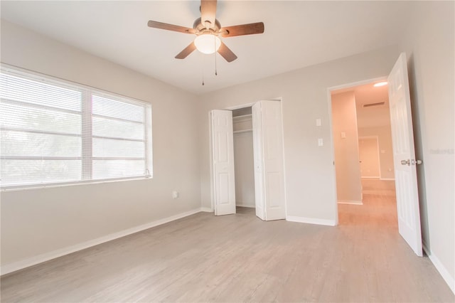 unfurnished bedroom featuring ceiling fan, a closet, and light hardwood / wood-style floors