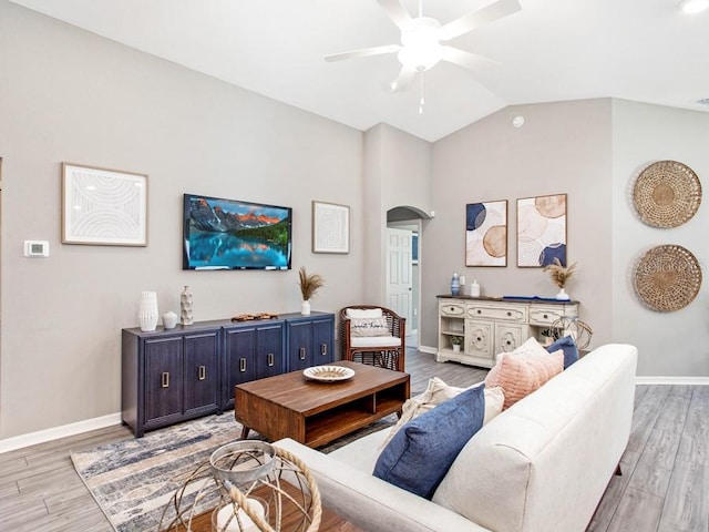 living room featuring lofted ceiling, ceiling fan, and hardwood / wood-style flooring