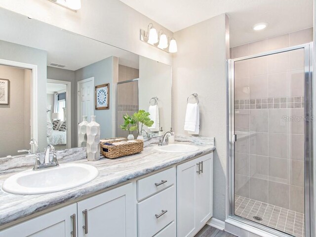 bathroom featuring walk in shower and vanity