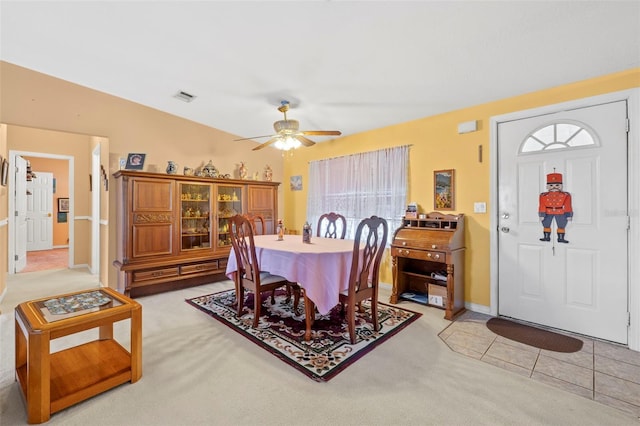 carpeted dining room featuring vaulted ceiling and ceiling fan