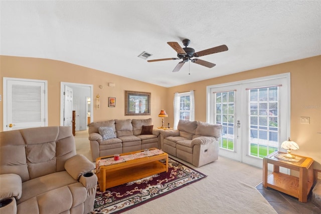 carpeted living room with a textured ceiling, lofted ceiling, and ceiling fan