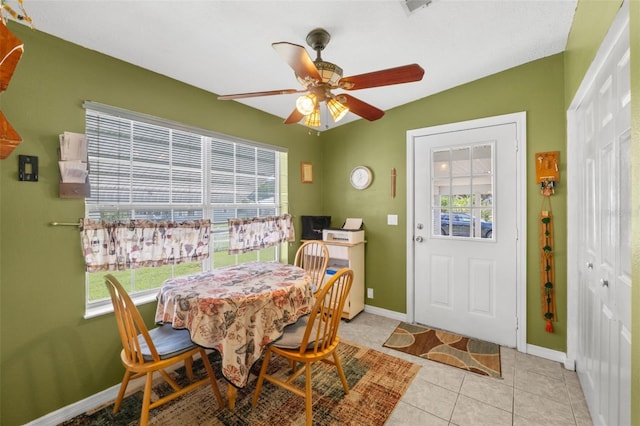 tiled dining room featuring lofted ceiling, ceiling fan, and a healthy amount of sunlight