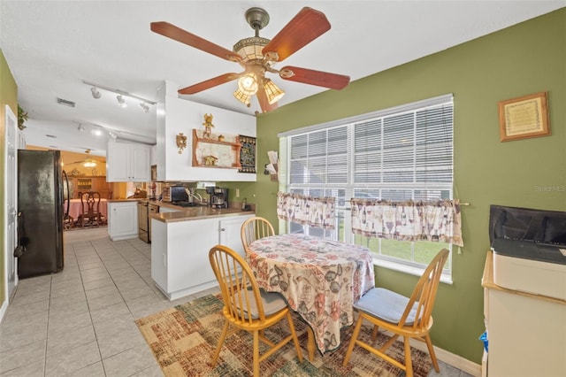 dining room with ceiling fan and light tile patterned floors