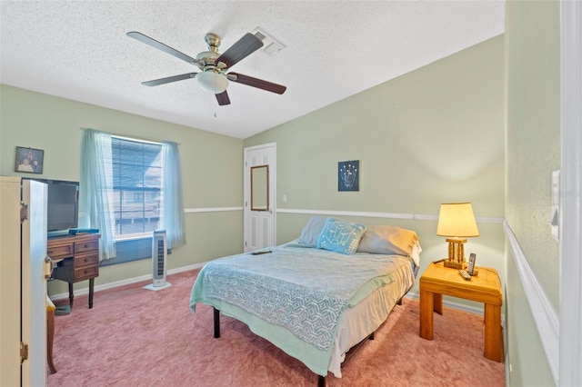 carpeted bedroom featuring ceiling fan, a textured ceiling, and vaulted ceiling