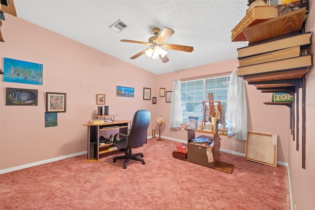 office space featuring ceiling fan, a textured ceiling, lofted ceiling, and carpet flooring