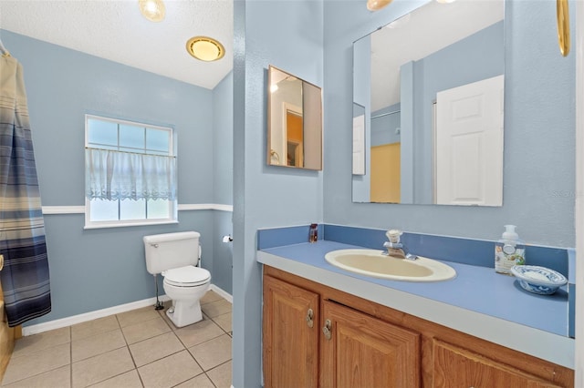 bathroom with vanity, tile patterned flooring, toilet, and a textured ceiling