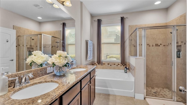 bathroom featuring independent shower and bath, vanity, and tile patterned floors