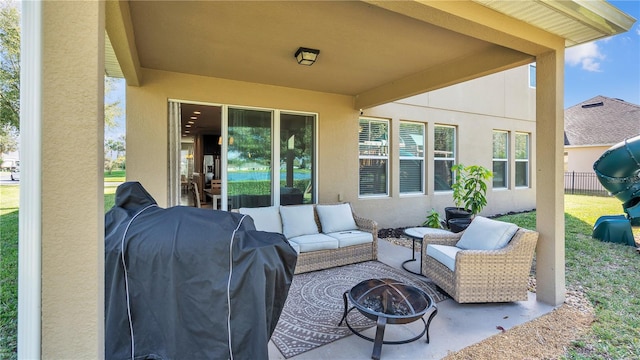 view of patio with an outdoor living space with a fire pit