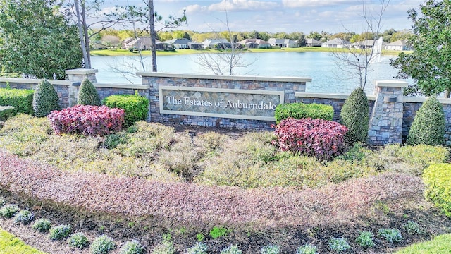 community / neighborhood sign with a water view