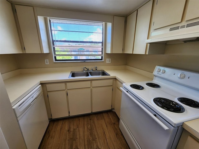 kitchen with dark hardwood / wood-style floors, cream cabinetry, white appliances, and sink