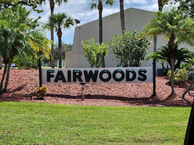 community / neighborhood sign with a lawn