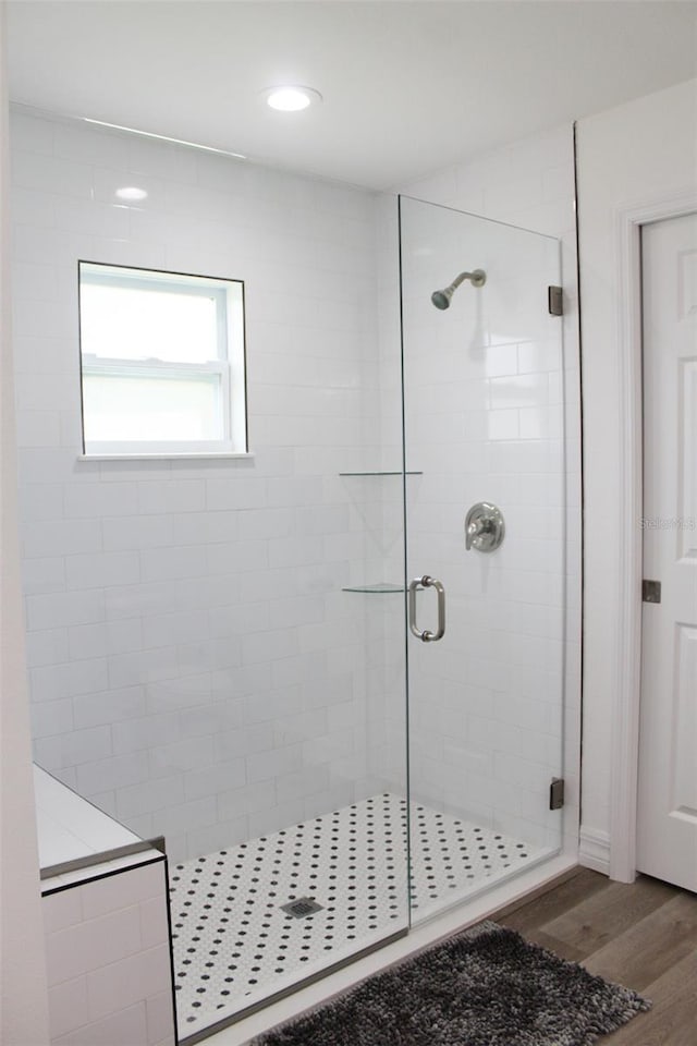 bathroom featuring walk in shower and hardwood / wood-style floors