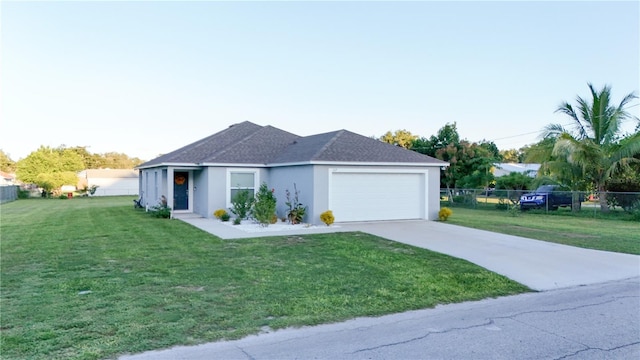 view of front of home with a garage and a front lawn