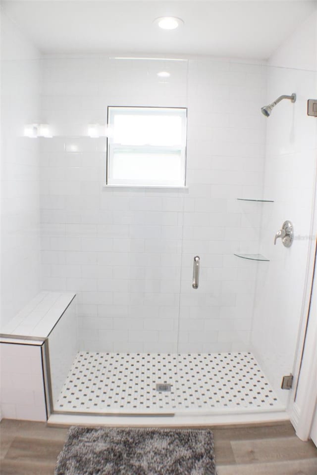 bathroom with wood-type flooring and walk in shower