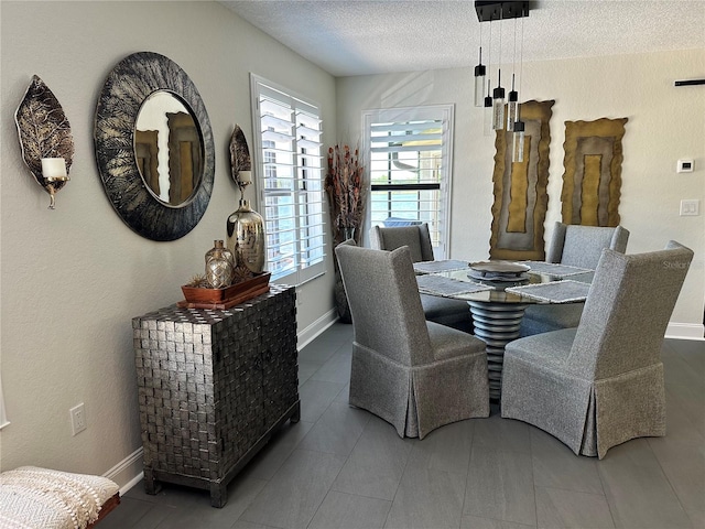 dining space featuring a textured ceiling