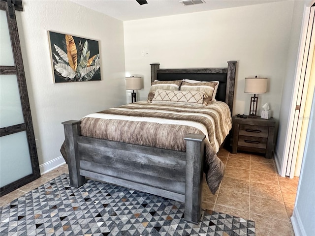 tiled bedroom featuring baseboards and visible vents