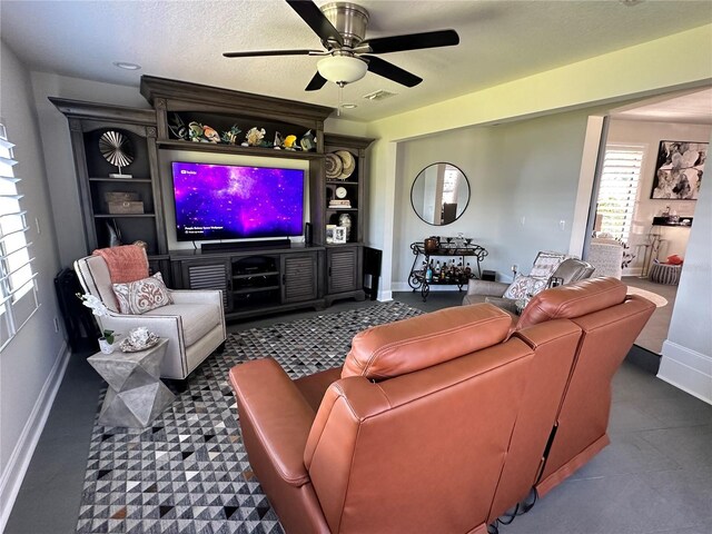 living room featuring a textured ceiling and ceiling fan