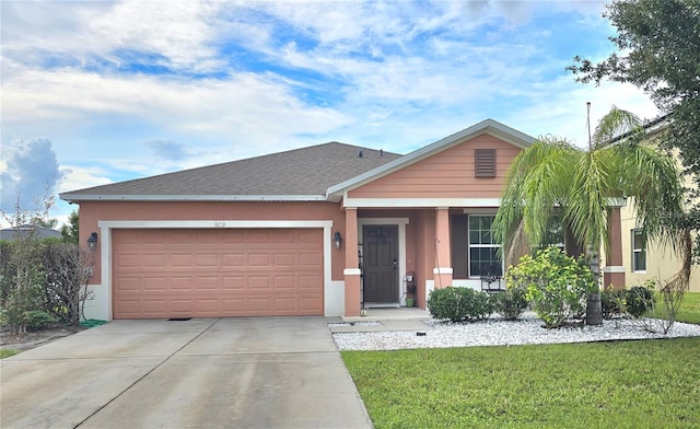 view of front of property with a front yard and a garage