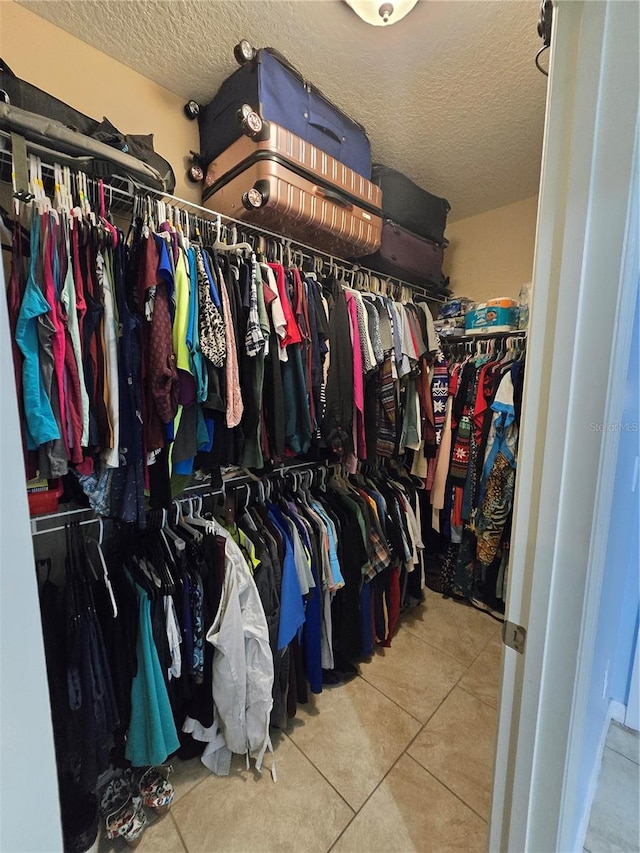 spacious closet with tile patterned floors